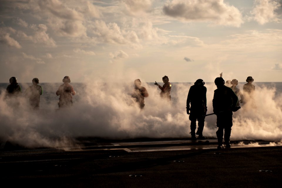 US Navy 110909-N-BT887-262 Sailors prep the catapult after launching an F-A-18C Hornet aboard the Nimitz-class aircraft carrier USS John C. Stennis