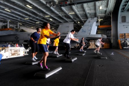 US Navy 110905-N-TU894-022 Lt. Cmdr. Tracy L. Vincent, front, leads a step class in the hangar bay aboard the aircraft carrier USS George H.W. Bush
