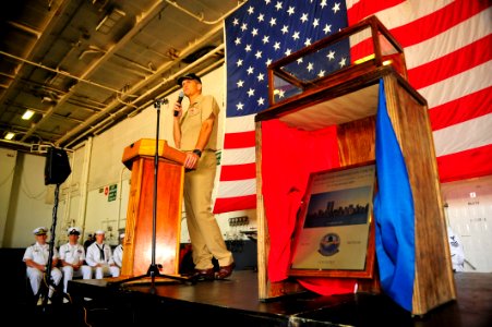US Navy 110909-N-MH885-014 Capt. David A. Lausman stands next to a enclosed, glass case containing a piece of the World Trade Center towers as he a
