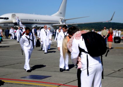 US Navy 110909-N-ZK021-001 A Sailor greets a loved one during a homecoming ceremony at Naval Air Station Whidbey Island photo