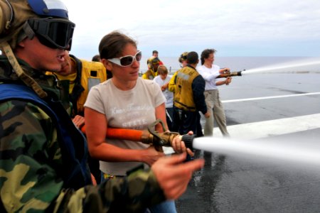 US Navy 110906-N-EE987-085 Aviation Boatswain's Mate 3rd Class Erin Herring assists tigers as they spray a fire hose during a crash and salvage dem