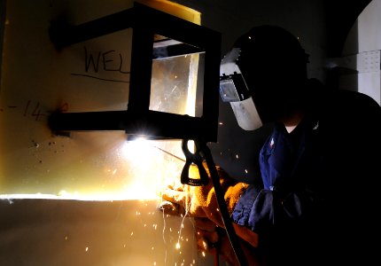US Navy 110908-N-QL471-265 Hull Maintenance Technician 3rd Class Erick C. Harvey welds a bracket to a bulkhead aboard the aircraft carrier USS Geor
