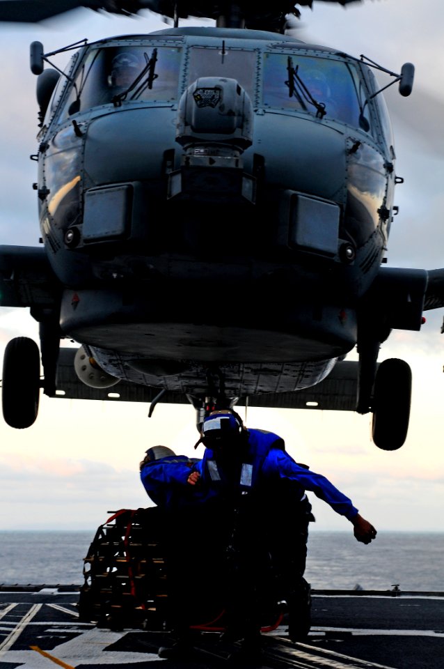 US Navy 110910-N-BC134-700 Sailors connect a cargo pendant to an MH-60 Sea Hawk helicopter