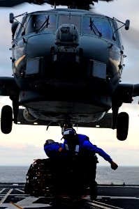 US Navy 110910-N-BC134-700 Sailors connect a cargo pendant to an MH-60 Sea Hawk helicopter