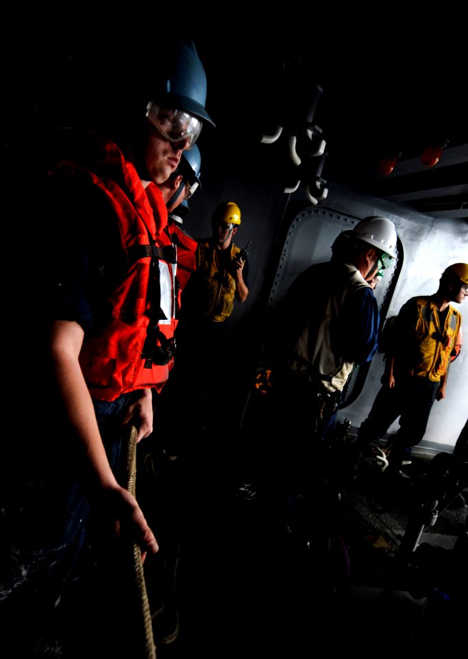 US Navy 110907-N-GZ277-066 Sailors assigned to deck department prepare to give slack to release a fuel hose during a replenishment at sea aboard th