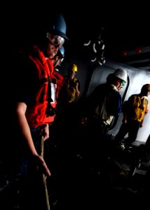 US Navy 110907-N-GZ277-066 Sailors assigned to deck department prepare to give slack to release a fuel hose during a replenishment at sea aboard th