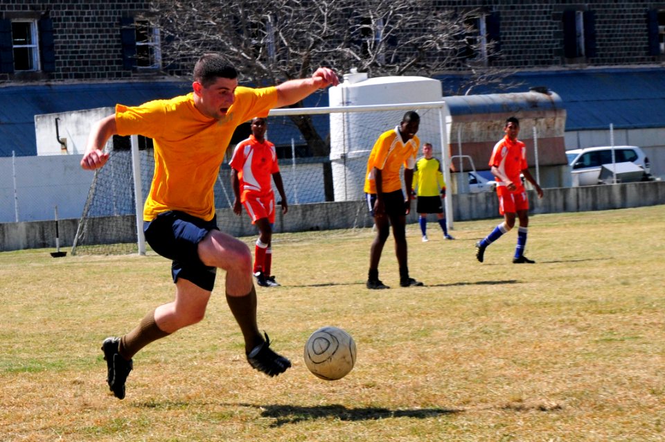 US Navy 110910-N-IZ292-226 Lt. Matt Bayer, assigned to the guided-missile frigate USS Samuel B. Roberts (FFG 58), kicks the ball during a soccer ga