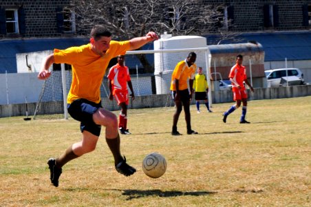 US Navy 110910-N-IZ292-226 Lt. Matt Bayer, assigned to the guided-missile frigate USS Samuel B. Roberts (FFG 58), kicks the ball during a soccer ga