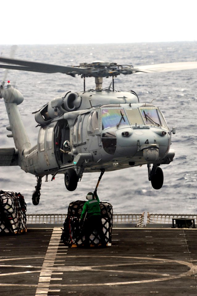 US Navy 110911-N-OY799-303 A Sailor aboard the Military Sealift Command fast combat support ship USNS Rainier (T-AOE 7) hooks pallets