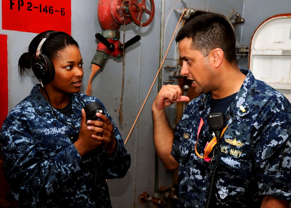 US Navy 110908-N-BK435-004 Ensign John Araiza, right, trains Interior Communications Electrician Fireman Breaune Sajna during a damage control dril