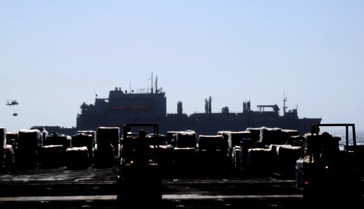 US Navy 110908-N-XE109-085 Sailors aboard the aircraft carrier USS George H.W. Bush (CVN 77) move cargo off an aircraft elevator into the hangar b