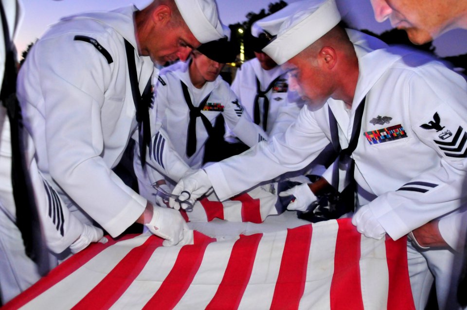 US Navy 110911-N-SM578-037 Chief petty officer selects retire an American flag during a ceremony commemorating the ten-year anniversary of the Sept