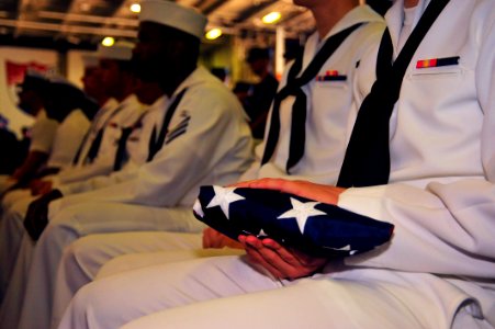 US Navy 110909-N-MH885-016 A Sailor holds the national ensign during the Patriot's Day ceremony in recognition of the 10th anniversary of the Sept