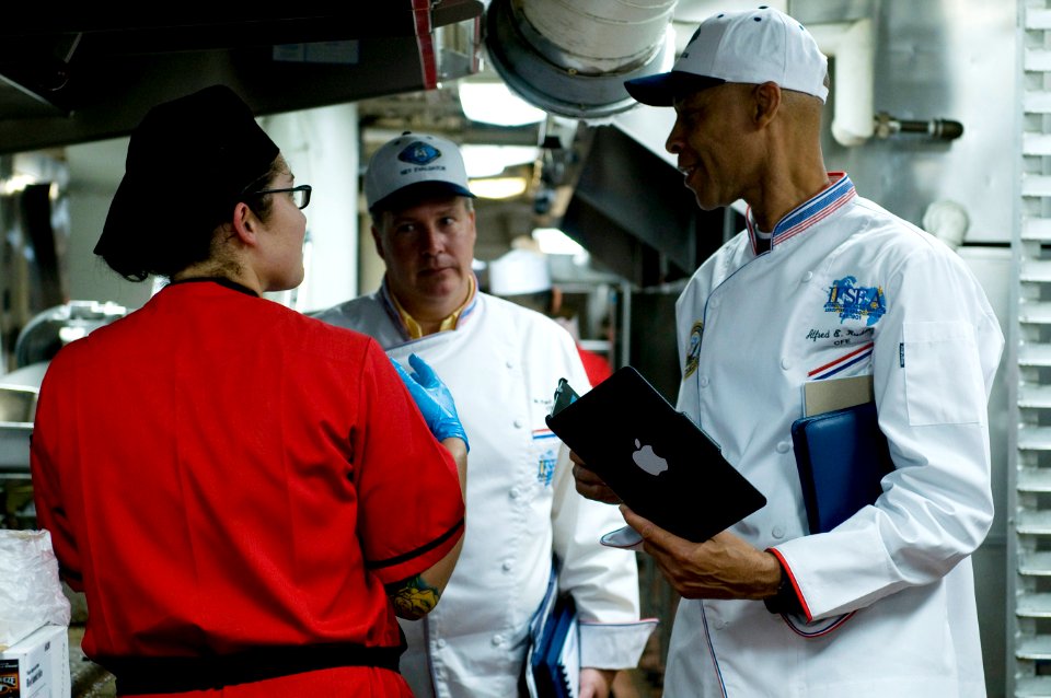 US Navy 110913-N-MD252-453 Evaluators for the Edward F. Ney Memorial Award for food excellence speak to Culinary Specialist 3rd Class Tika Torres