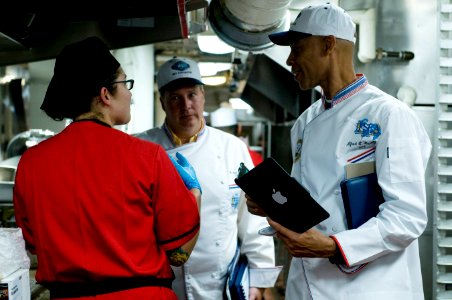 US Navy 110913-N-MD252-453 Evaluators for the Edward F. Ney Memorial Award for food excellence speak to Culinary Specialist 3rd Class Tika Torres