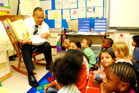 US Navy 110908-N-GO179-001 Harold Jones, a paralegal specialist and diversity officer at Navy Medicine Support Command, reads to first-grade studen