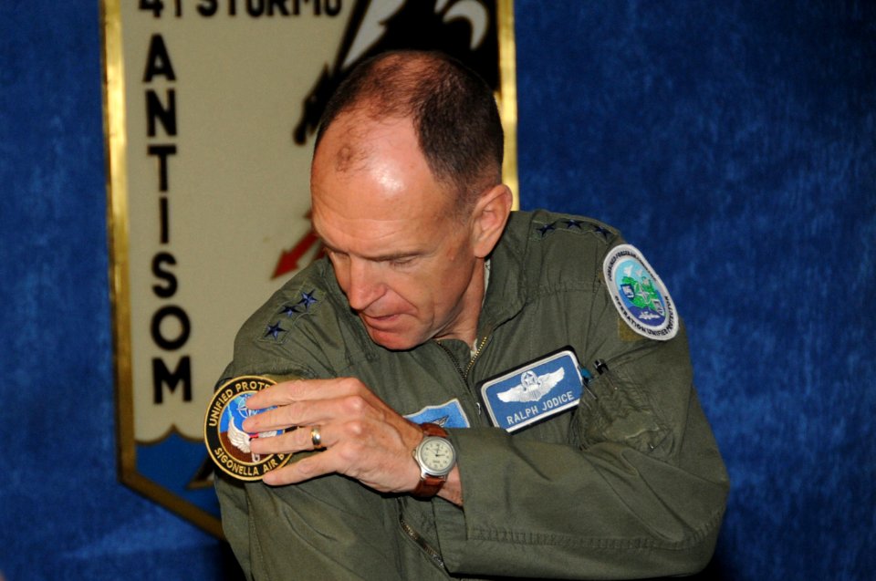 US Navy 110913-N-RB564-010 Lt. Gen. Ralph J. Jodice II, commander of Combined Forces Air Component, replaces his shoulder patch with one from Naval