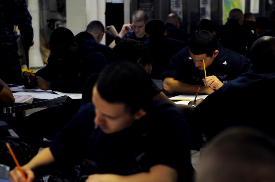 US Navy 110908-N-JD217-063 Aviation Ordnanceman 3rd Class Robert H. Little takes the E-5 Navy-wide advancement exam on the mess decks
