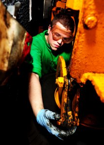 US Navy 110910-N-OI955-022 Aviation Support Equipment Technician Airman Mark Richards, from Columbus, Ohio, conducts preventative maintenance on a