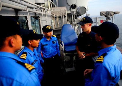 US Navy 110908-N-ZZ999-776 Ensign John Ondik speaks with Royal Malaysian navy officers aboard the Ticonderoga-class guided-missile cruiser USS Mobi