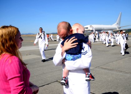 US Navy 110909-N-ZK021-002 Logistics Specialist 2nd Class James McDowell hugs his son during a homecoming ceremony at Naval Air Station Whidbey Isl photo