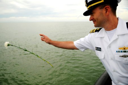 US Navy 110910-N-WP746-313 Lt. Cmdr. Dennis Foutz offers a flower in remembrance of lives lost during the Battle of Lake Erie as Neah Bay (WTGB 105
