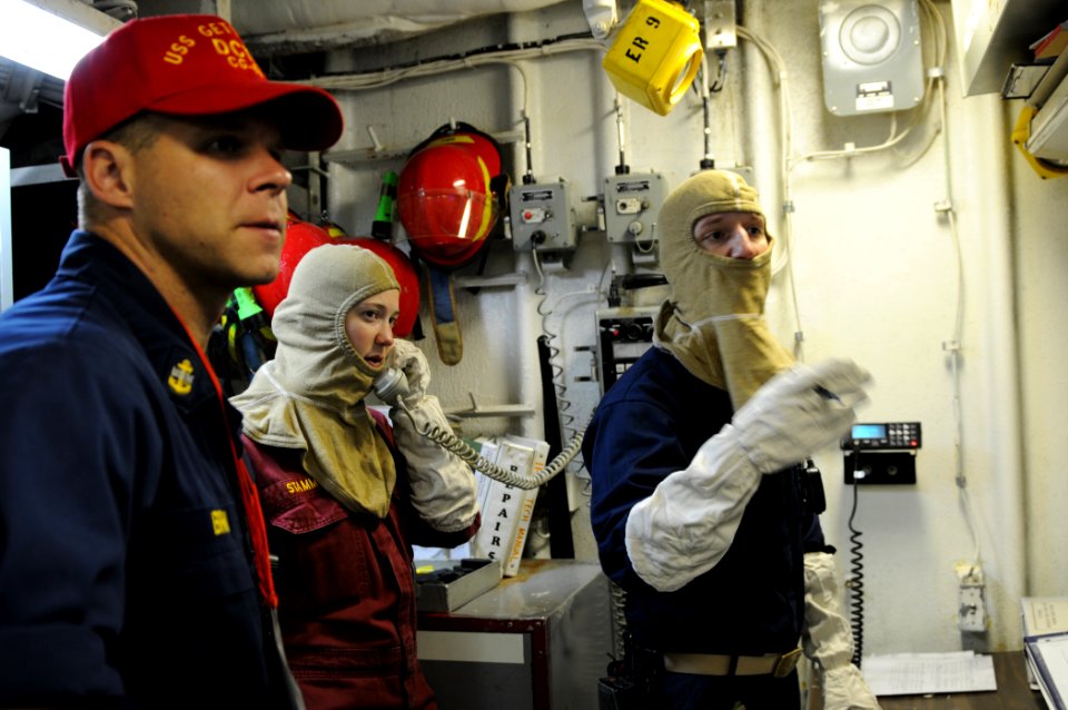 US Navy 110910-N-DU438-048 Chief Personnel Specialist Michael Brown, left, Ensign Stephanie Stamm, and Ensign Jesse Duparc relay information during