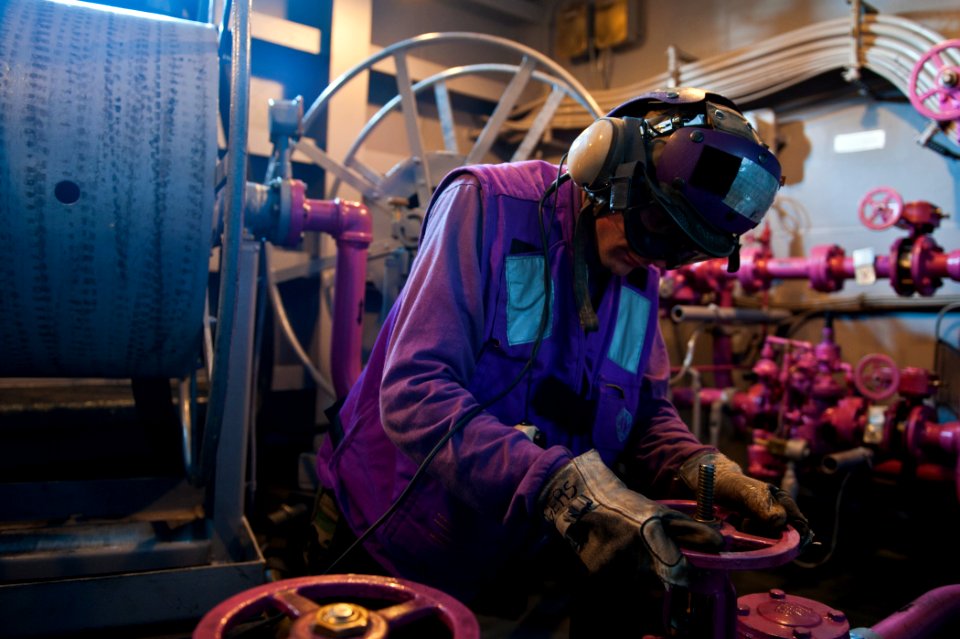 US Navy 110915-N-BT887-174 Aviation Boatswain's Mate (Fuel) Airman Justin Rogers, from The Colony, Texas, opens a fuel valve aboard the Nimitz-clas