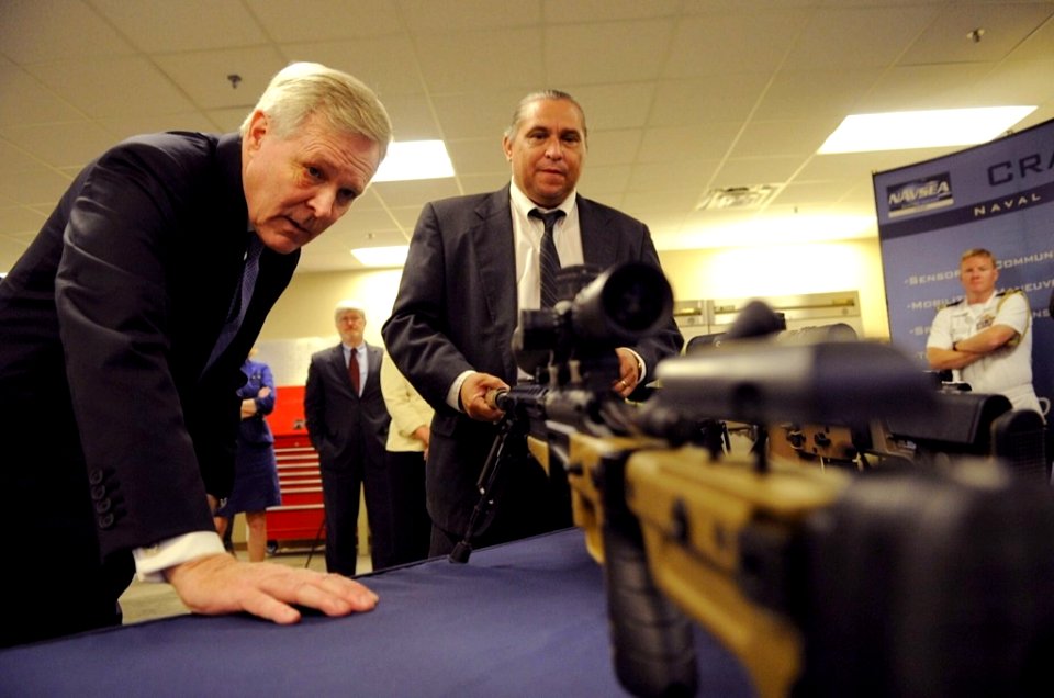 US Navy 110913-N-AC887-002 Secretary of the Navy (SECNAV) the Honorable Ray Mabus examines a Mark 13 assault rifle during a visit to Naval Surface