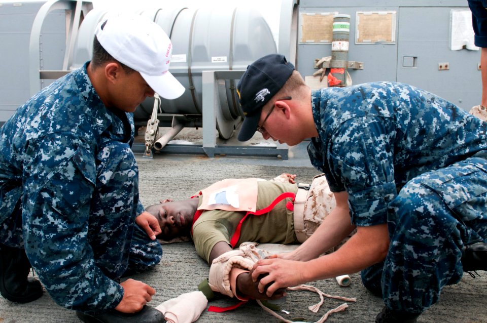 US Navy 110909-N-PB383-136 Hospital Corpsman 3rd Class Benoit Cisneros observes Seaman Juan Villagarcia provide medical assistance to Hospital Corp
