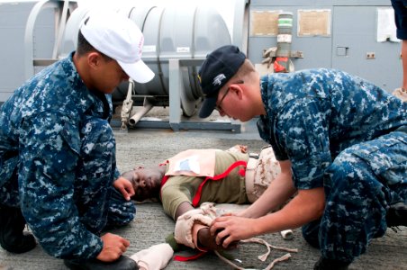 US Navy 110909-N-PB383-136 Hospital Corpsman 3rd Class Benoit Cisneros observes Seaman Juan Villagarcia provide medical assistance to Hospital Corp