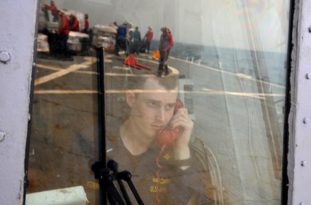 US Navy 110911-N-XQ375-391 Lt. j.g. Ken Kerr, disbursing officer and helicopter control officer aboard the guided-missile destroyer USS Mitscher (D
