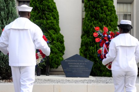 US Navy 110911-N-MU720-032 Chief (select) Yeoman Demetrius Taylor, left, and Chief (select) Master-at-Arms Pamela Almozon, right, prepare to lay a