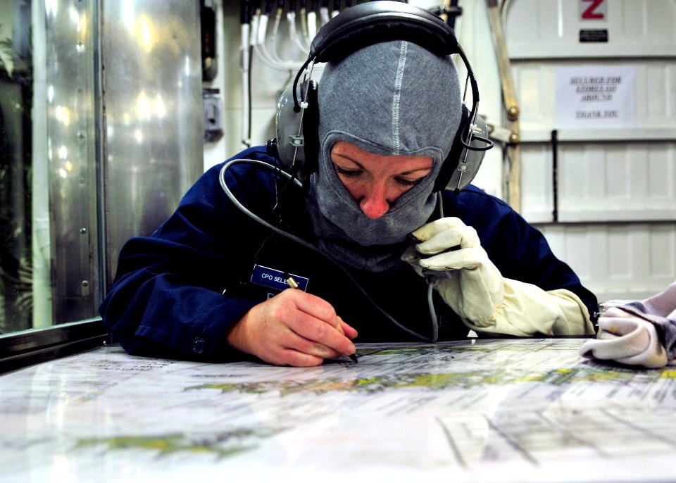 US Navy 110913-N-ZF681-232 Chief (Select) Boatswain's Mate Kimberly Ford plots the location of a fire during a damage control exercise aboard the g