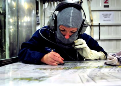 US Navy 110913-N-ZF681-232 Chief (Select) Boatswain's Mate Kimberly Ford plots the location of a fire during a damage control exercise aboard the g