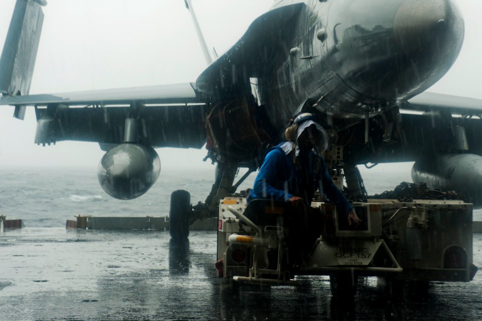 US Navy 110912-N-BT887-245 Aviation Boatswain's Mate (Handling) Airman Joe Phinazee, from Atlanta, Ga., moves an F-A-18C Hornet