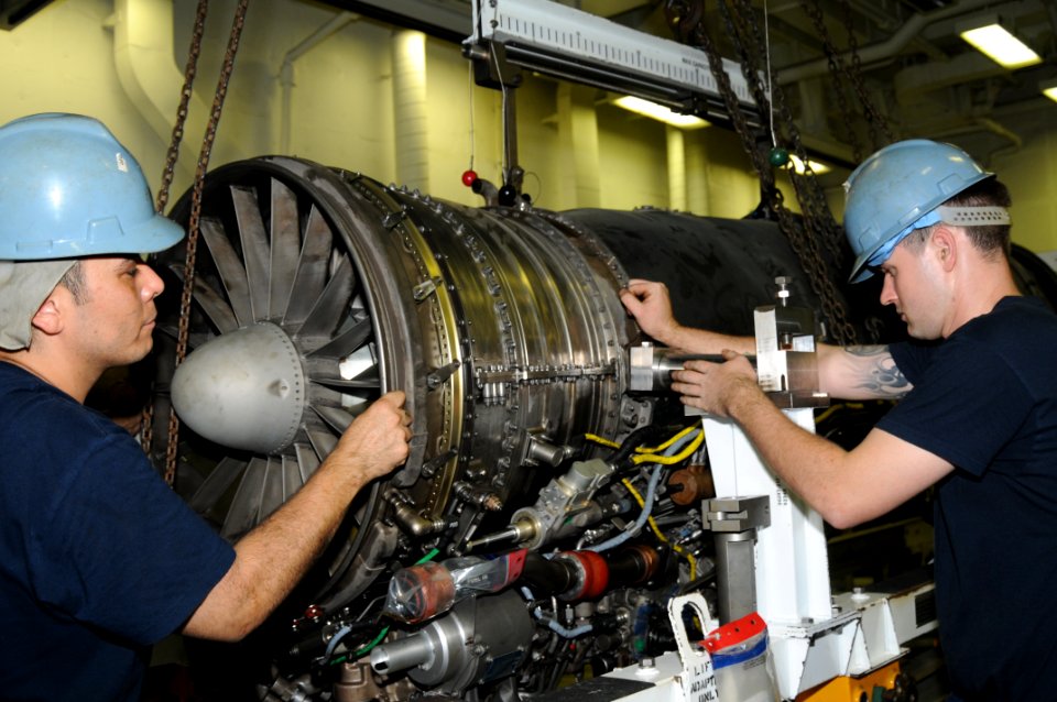 US Navy 110914-N-TU894-058 Aviation Machinist's Mate 2nd Class Ubaldo Herrera, left, and Aviation Machinist's Mate 3rd Class Brian W. Hauff move a