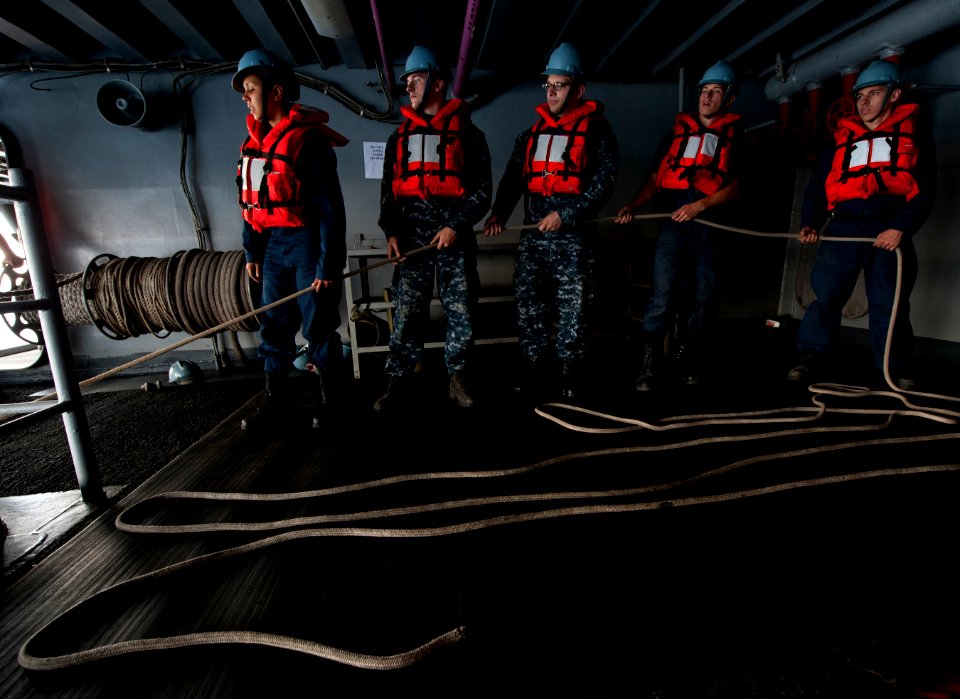 US Navy 110913-N-DR144-699 Deck department Sailors recover a rigid hull inflatable boat during a man overboard drill aboard the Nimitz-class aircra
