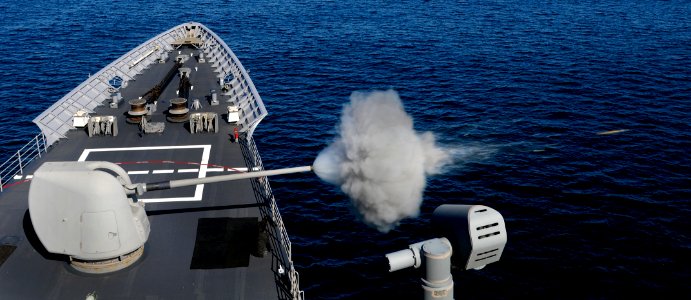 US Navy 110912-N-BC134-176 The MK-45 5-inch-54-caliber lightweight gun of the guided-missile cruiser USS Bunker Hill (CG 52) is fired during a live photo