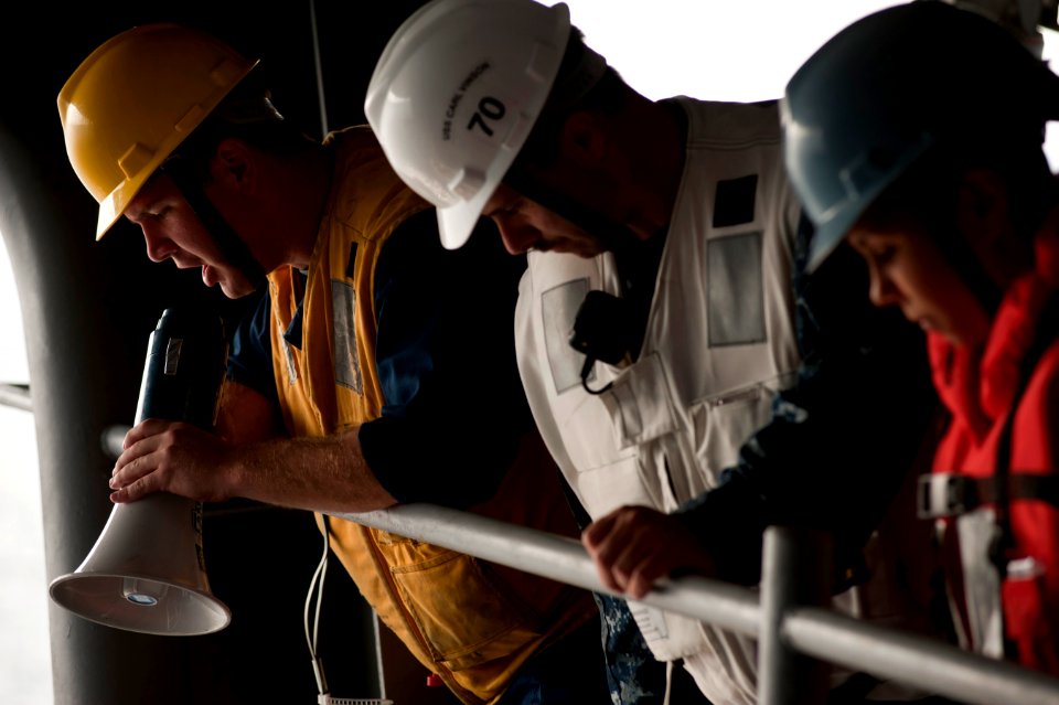 US Navy 110913-N-DR144-348 Rig Captain Boatswain's Mate 2nd Class Christopher Cook gives orders as deck department Sailors launch a rigid hull infl