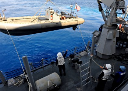 US Navy 110913-N-VH839-002 Sailors aboard the Arleigh Burke-class guided-missile destroyer USS Dewey (DDG 105) lower a rigid hull inflatable boat