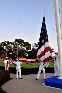 US Navy 110911-N-SM578-015 Chief petty officer selects lower the American flag during a ceremony commemorating the ten-year anniversary of the Sept photo