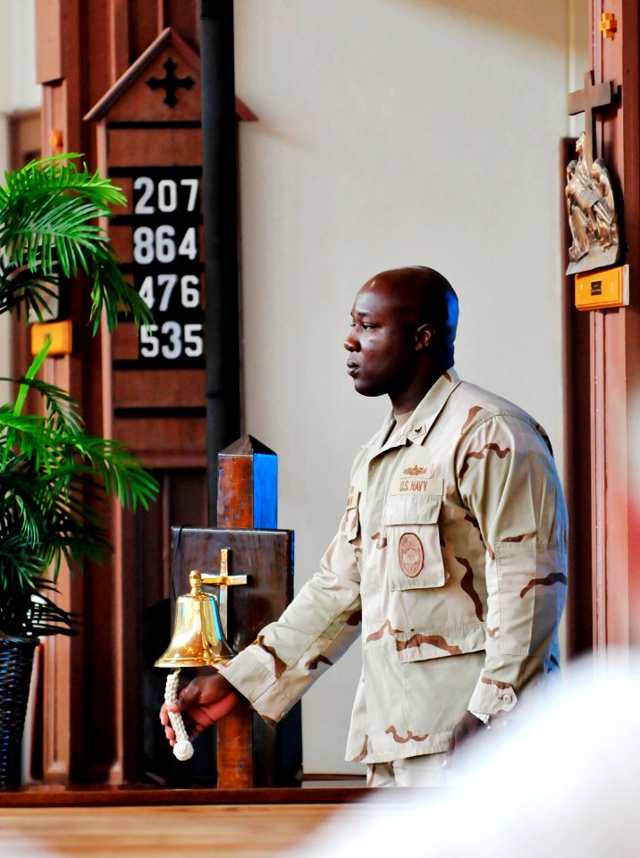 US Navy 110911-N-RF645-167 Boatswain's Mate 3rd Class Brandon Wildman rings the bell honoring those lost on Sept. 11, 2001 during a remembrance ser