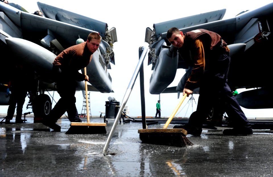 US Navy 110915-N-ZZ999-563 Aviation Machinist's Mate Airmen Kevin May, from Fremont, Calif., and Ken Azevedo, from Reno, Nev., clear water off the