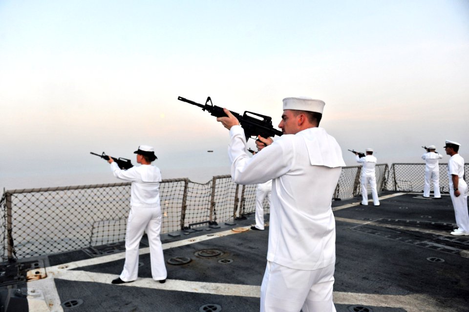 US Navy 110911-N-YZ751-111 Fire Controlman 3rd Class Richard P. Boughton fires a rifle volley aboard the guided-missile destroyer USS Truxtun (DDG
