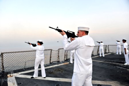 US Navy 110911-N-YZ751-111 Fire Controlman 3rd Class Richard P. Boughton fires a rifle volley aboard the guided-missile destroyer USS Truxtun (DDG