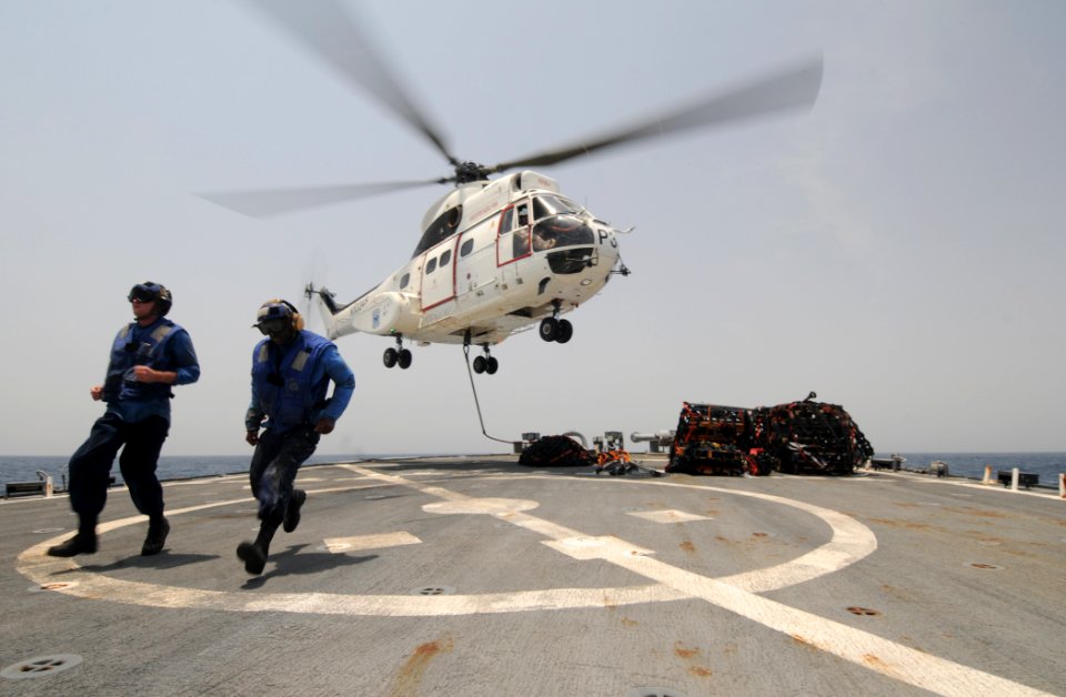 US Navy 110911-N-XQ375-521 Seaman Matt Binnie, left, and Boatswain's Mate Seaman Recruit Jonathan Richardson clear the flight deck of the guided-mi