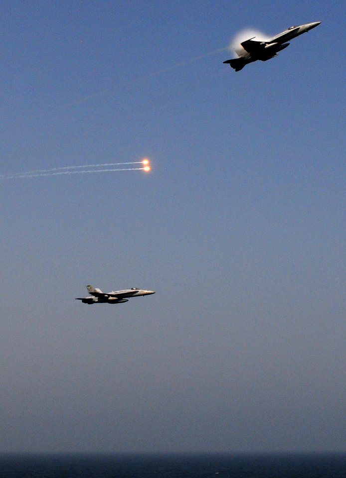 US Navy 110917-N-XE109-173 F-A-18A- Hornets release flares during an aerial change of command ceremony