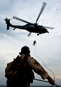US Navy 110914-N-BT887-386 A Sailor assigned to Explosive Ordnance Disposal Mobile Unit (EODMU) 11 anchors a repelling line during training aboard