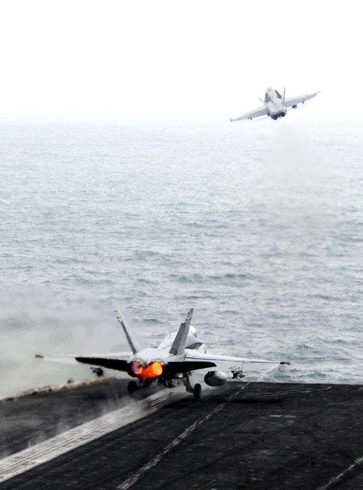 US Navy 110918-N-QL471-273 An F-A-18C Hornet assigned to Strike Fighter Squadron (VFA) 15, right, and an F-A-18A- Hornet assigned to VFA 87 launch